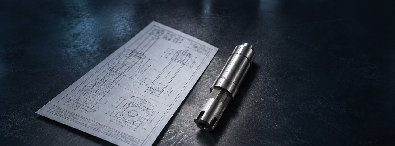 Metal tool beside a technical drawing